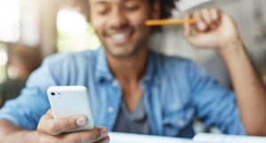 technology-communication-man-using-cell-phone-smiling