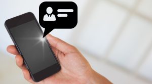 a hand using smartphone with text